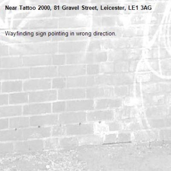 Wayfinding sign pointing in wrong direction.-Tattoo 2000, 81 Gravel Street, Leicester, LE1 3AG