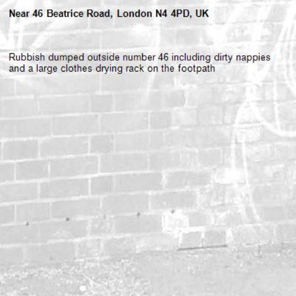 Rubbish dumped outside number 46 including dirty nappies and a large clothes drying rack on the footpath -46 Beatrice Road, London N4 4PD, UK