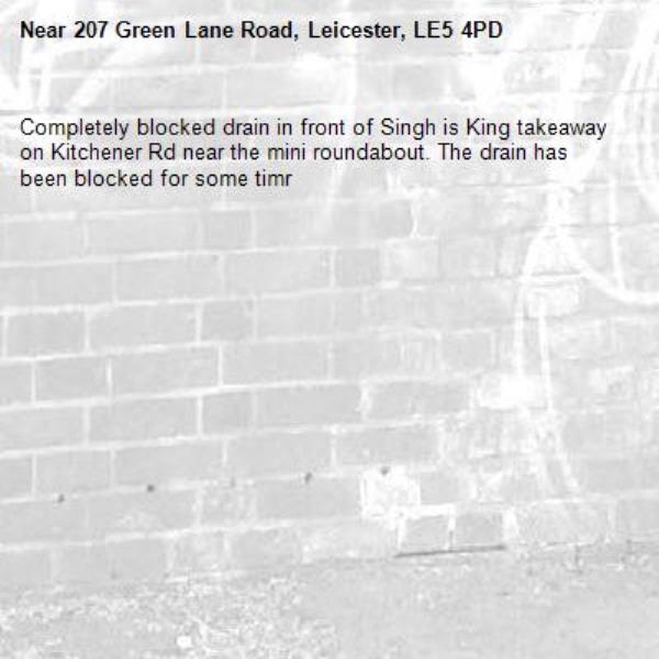 Completely blocked drain in front of Singh is King takeaway on Kitchener Rd near the mini roundabout. The drain has been blocked for some timr-207 Green Lane Road, Leicester, LE5 4PD