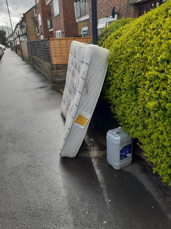 A mattress and an empty container dumped outside block 82 to 110 New Barn Street E13 -102 New Barn Street, Plaistow, London, E13 8JW