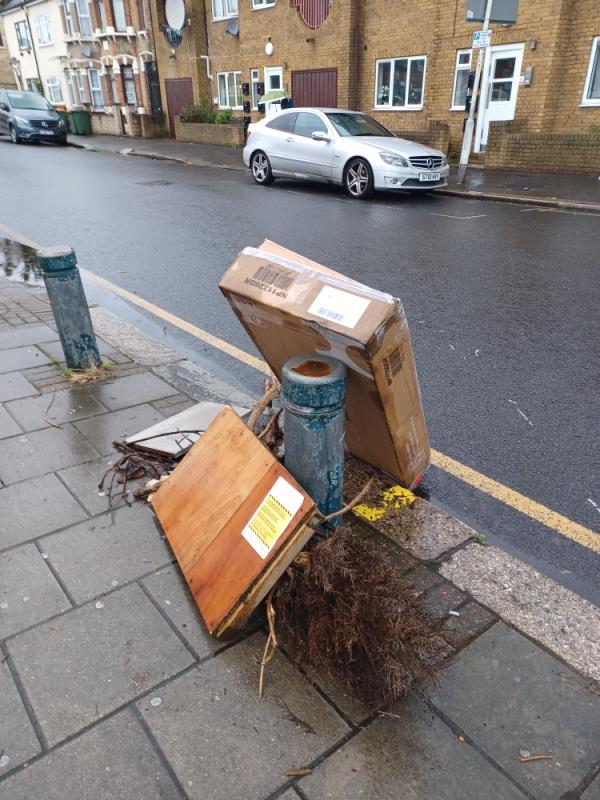 Cardboard box, wooden board and garden waste fly tipped outside the car park, near 87 Shaftesbury Road, E7.-87 Shaftesbury Road, Forest Gate, London, E7 8PD