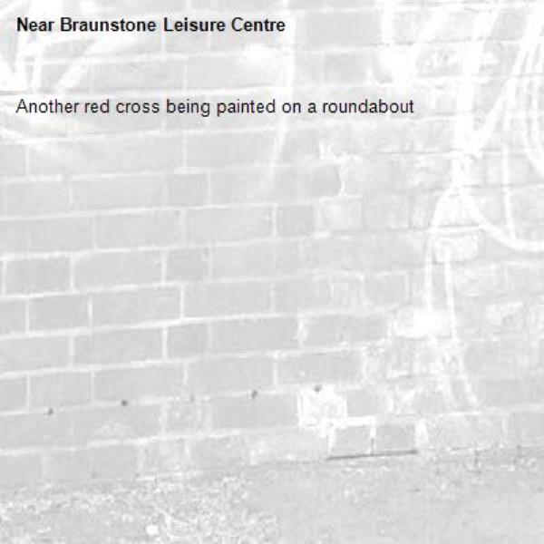Another red cross being painted on a roundabout -Braunstone Leisure Centre