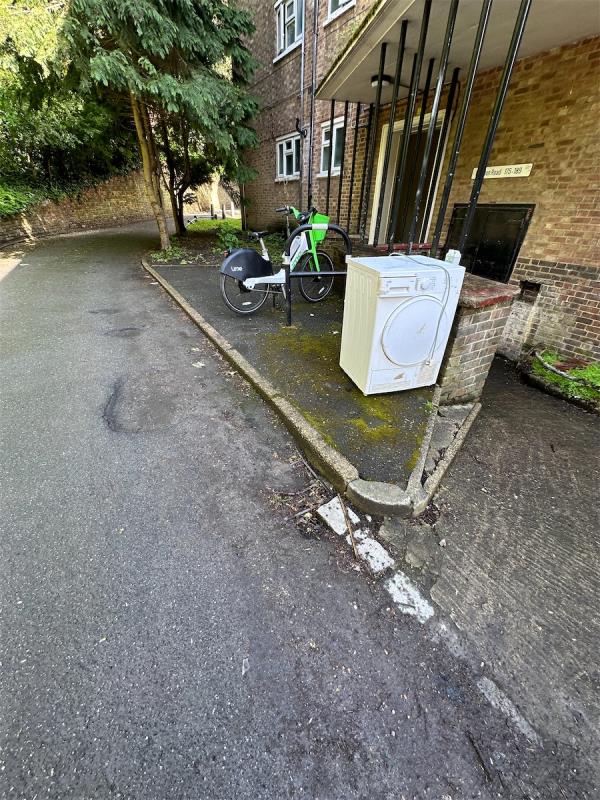 Flytipped washing machine by entrance to block of flats-175 Baizdon Road, Blackheath, London, SE3 0UH
