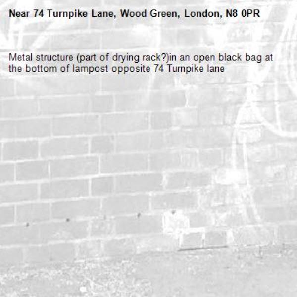 Metal structure (part of drying rack?)in an open black bag at the bottom of lampost opposite 74 Turnpike lane-74 Turnpike Lane, Wood Green, London, N8 0PR