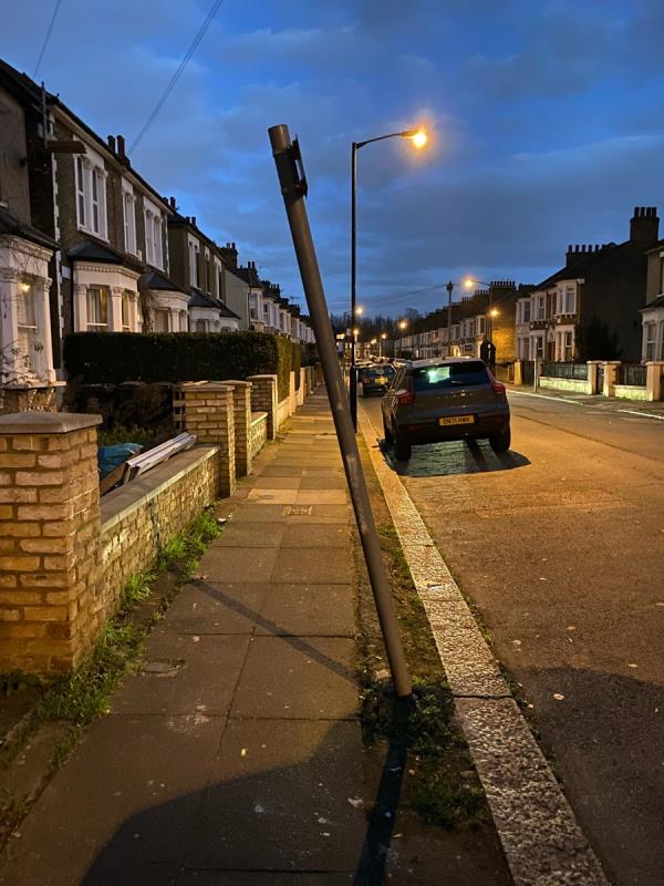 Metal pole bent out of the ground and falling further away from vertical, becoming an obstruction and a safety hazard. -19 Honley Road, Catford, SE6 2HY, England, United Kingdom