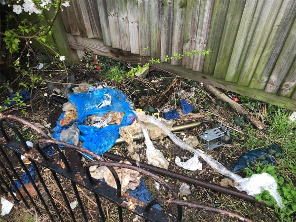 Please clear flytip waste from shrub bed  up steps next to Mr Chippy-626 Downham Way, Bromley, BR1 5HW