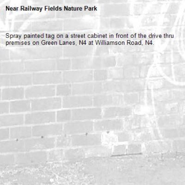 Spray painted tag on a street cabinet in front of the drive thru premises on Green Lanes, N4 at Williamson Road, N4.-Railway Fields Nature Park