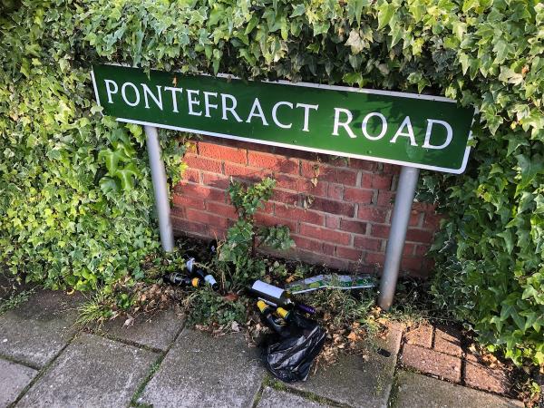 Please clear bottles from under street sign-47 Pontefract Road, Bromley, BR1 4RA