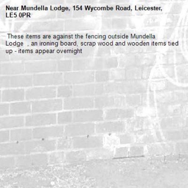  These items are against the fencing outside Mundella Lodge  , an ironing board, scrap wood and wooden items tied up - items appear overnight -Mundella Lodge, 154 Wycombe Road, Leicester, LE5 0PR