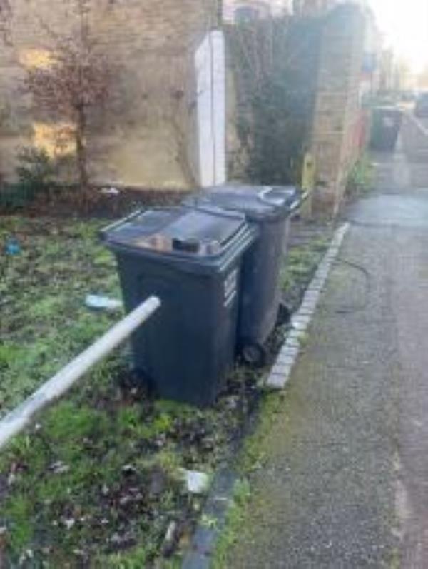 Please clear 2 Refuse bins from grass area-94 Hunsdon Road, New Cross Gate, SE14 5RF