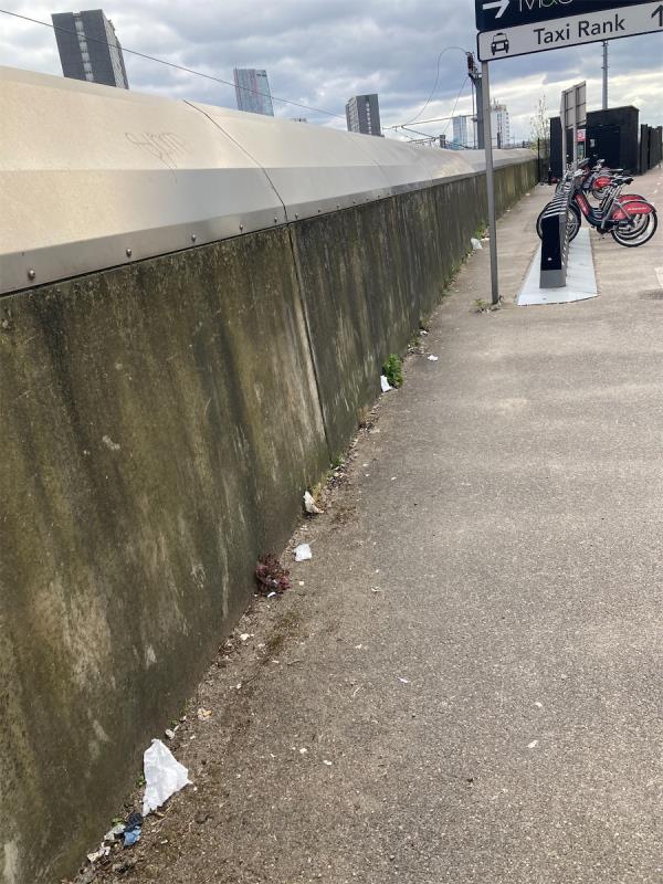 Montfichet Road. Walkway opposite Westfield need to be litter picked, next to the railway external wall-Travelex, 40a The Arcade, Westfield Stratford City, Montfichet Road, Stratford, London, E20 1EH