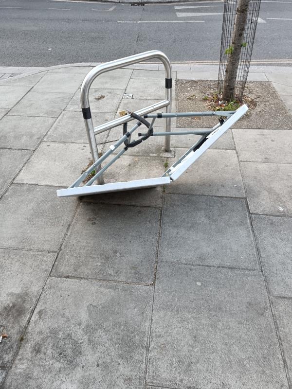 Camping table chained to the bike rack-53A, Woodgrange Road, Forest Gate, London, E7 0EL