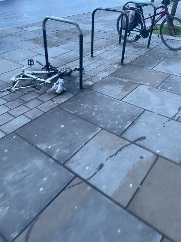 Abandoned bike chained to rack -179-183 Greenford Road, Greenford, UB6 8PJ