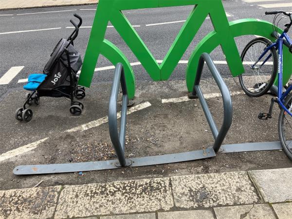 One half of cycle rack is completely unmoored from road surface. -29 Honor Oak Park, Crofton Park, London, SE23 1DZ
