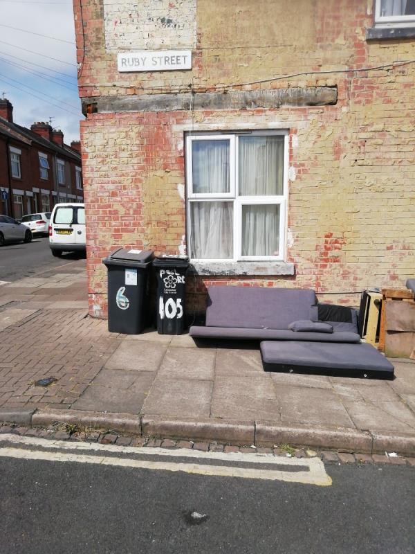 A stack of chairs 3 or 4, bags of broken fencing, bits of a settee and other bits of wood -111 Ruby Street, Leicester, LE3 9GS