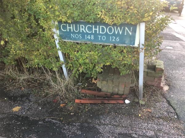 Remove flytip wood from under street sign (2)-124 Churchdown, Bromley, BR1 5PG