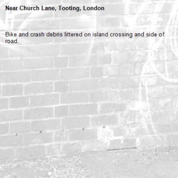 Bike and crash debris littered on island crossing and side of road. -Church Lane, Tooting, London