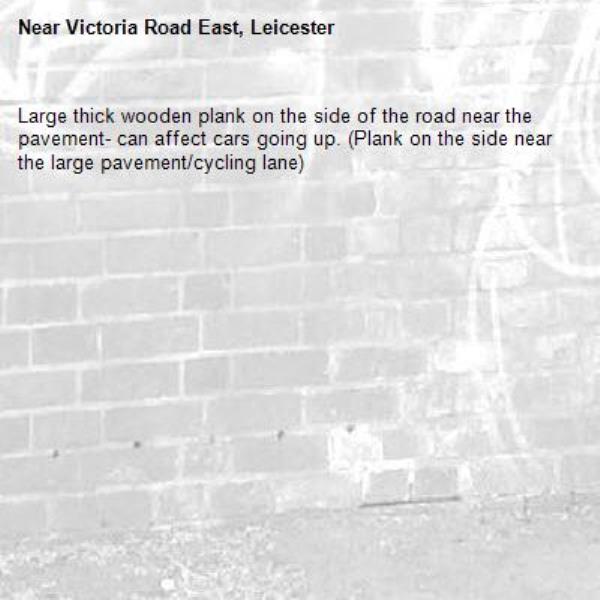 Large thick wooden plank on the side of the road near the pavement- can affect cars going up. (Plank on the side near the large pavement/cycling lane) -Victoria Road East, Leicester