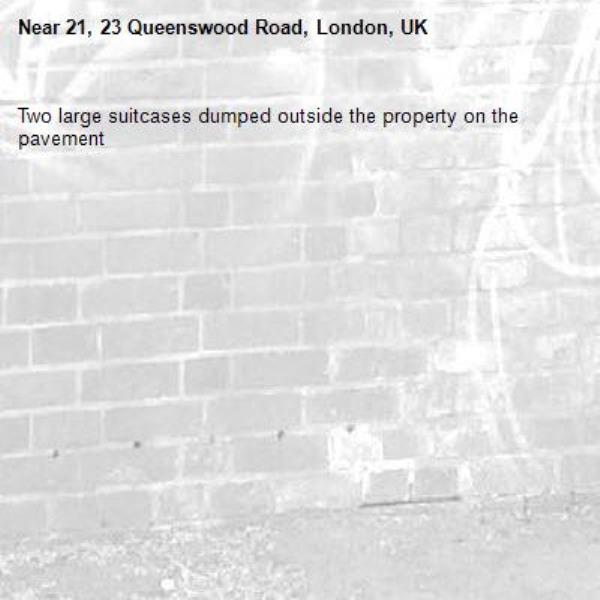 Two large suitcases dumped outside the property on the pavement-21, 23 Queenswood Road, London, UK