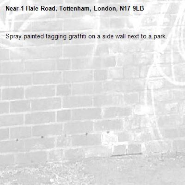 Spray painted tagging graffiti on a side wall next to a park.-1 Hale Road, Tottenham, London, N17 9LB