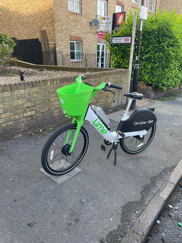Lime bike left by lane to Sydenham station -2S-9 Silverdale, London, SE26 4SD