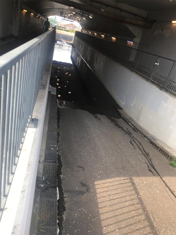 roadway completely flooded (more than a month) forcing cylists to use pedestrian walkways-Wharfside Road, Canning Town, London
