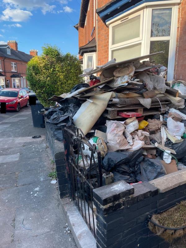 Dangerous pile of builders rubbish. Accumulating for last month or more. No skip. Now at risk of collapse onto pavement -57 Dulverton Road, Leicester, LE3 0SB