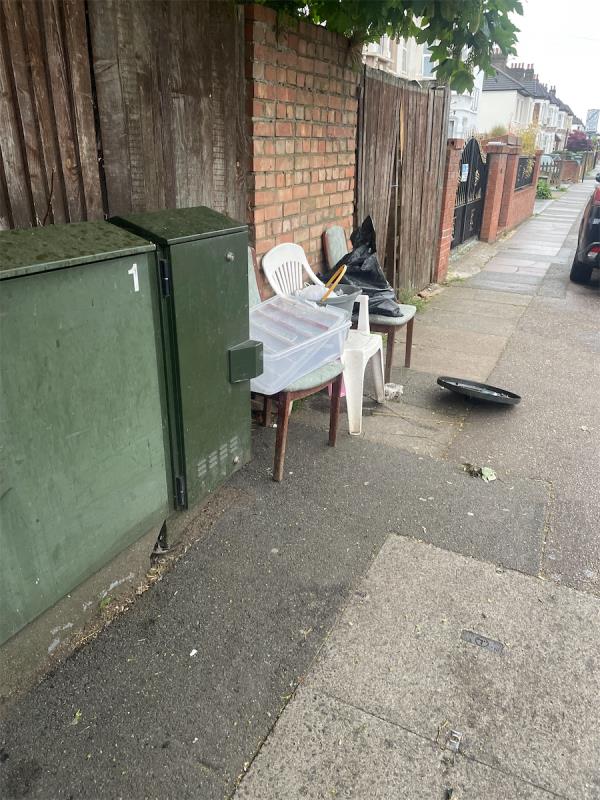Chairs boxes and bags dumped on pavement -90 Hazelbank Road, London, SE6 1TQ