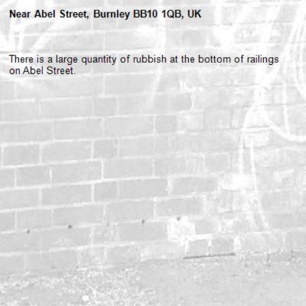 There is a large quantity of rubbish at the bottom of railings on Abel Street.-Abel Street, Burnley BB10 1QB, UK