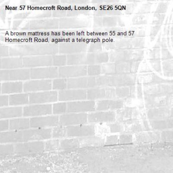 A brown mattress has been left between 55 and 57 Homecroft Road, against a telegraph pole. -57 Homecroft Road, London, SE26 5QN