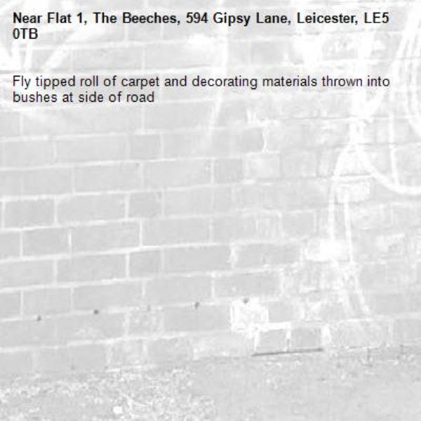 Fly tipped roll of carpet and decorating materials thrown into bushes at side of road-Flat 1, The Beeches, 594 Gipsy Lane, Leicester, LE5 0TB