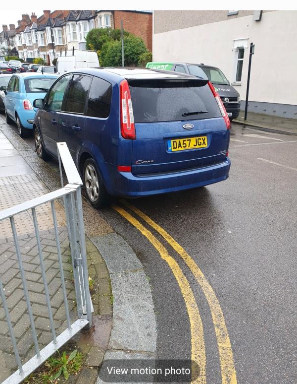 A vehicle parked on double yellow lines, blocking a safe crossing at the busy junction of Ewhurst / Bexhill Rd-28 Ewhurst Road, London, SE4 1AQ