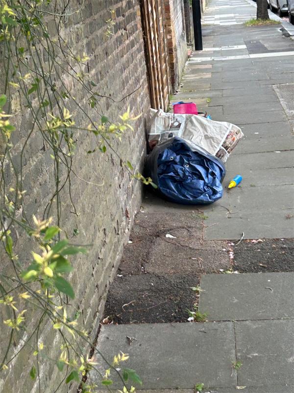 Rubbish dumped on pavement against brick wall -57A, Fairlawn Park, London, SE26 5SA