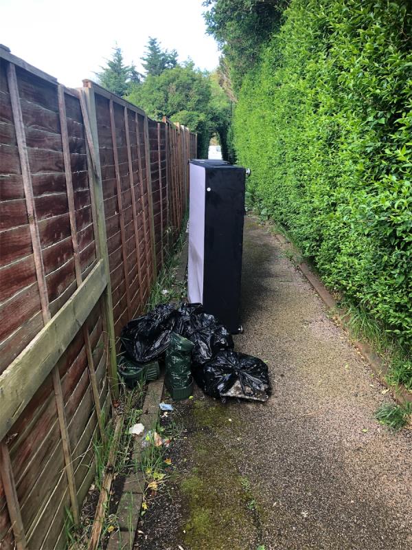 Estate footpath to rear of No 2 . Please clear a divan base and bags (Excalibur Estate)-2 Persant Road, London, SE6 1RW