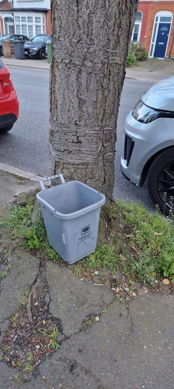 Abandoned bin first reported on 16/4.  Status completed on 19/4 but the bin has not been collected and is still by the tree. -221 Bellingham Road, Catford, London, SE6 1EQ