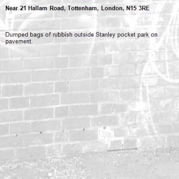 Dumped bags of rubbish outside Stanley pocket park on pavement. -21 Hallam Road, Tottenham, London, N15 3RE