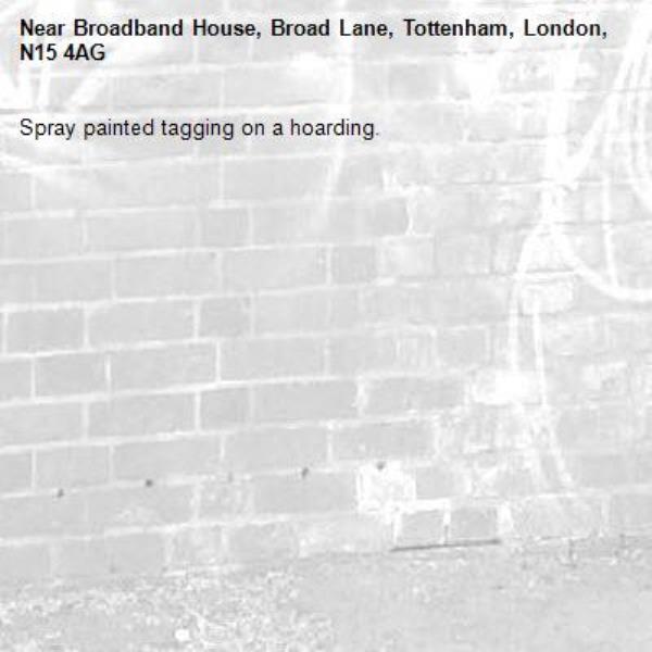 Spray painted tagging on a hoarding.-Broadband House, Broad Lane, Tottenham, London, N15 4AG