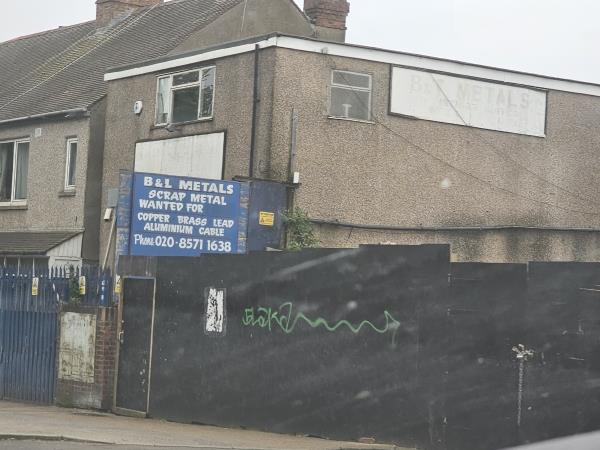 Grafitti on black hoarding-The Hambrough Tavern, The Hambrough Tavern, The Broadway, Southall, UB1 1NG