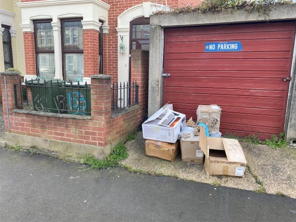 Boxes dumped outside garages next to 153 Byron avenue-155 Byron Avenue, Manor Park, London, E12 6NJ