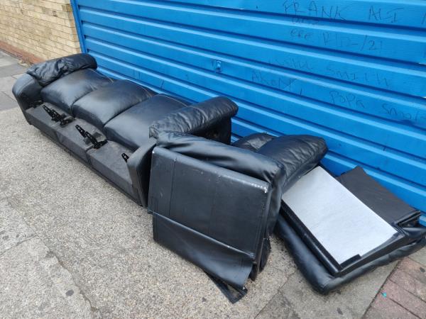 Leather sofa dumped outside garage at Upton Lane end of Kitchener Road -7 Kitchener Road, London, E7 8JL