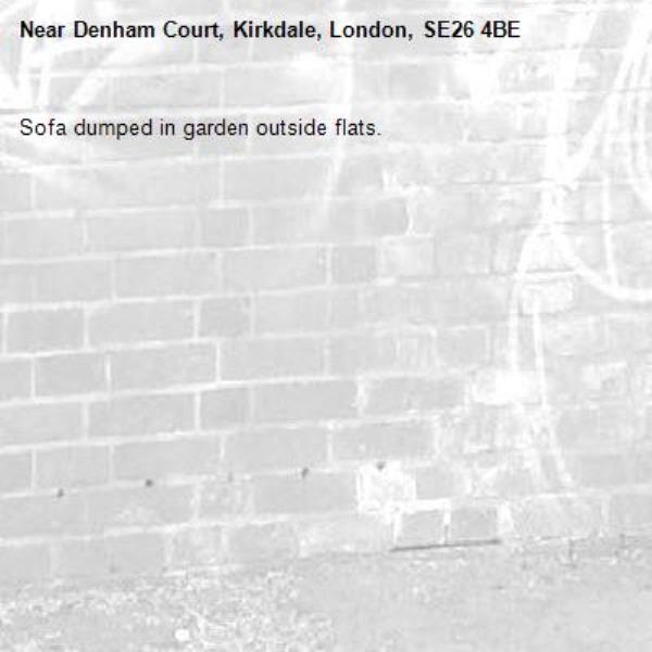 Sofa dumped in garden outside flats.-Denham Court, Kirkdale, London, SE26 4BE