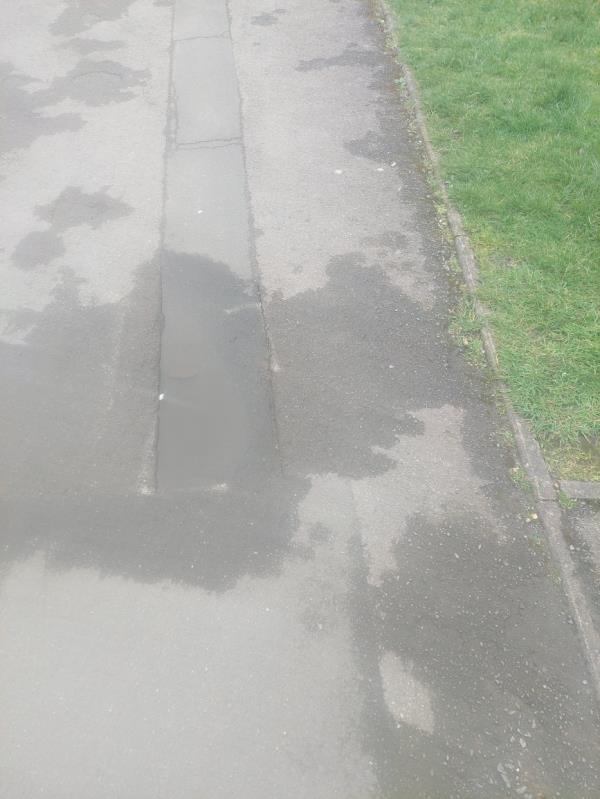 There's a dangerous dip in the pavement outside 15, Walnut Way, vausingva trip hazard on a busy stretch of pavement -19 Woodland Drive, Tilehurst, Reading, RG30 4RT