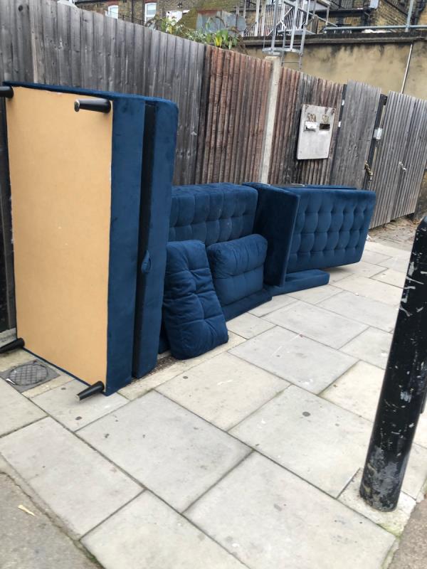 Sofa blue dumped on bottom of Warham road -509A Green Lanes, Harringay Ladder, London N4 1AL, UK