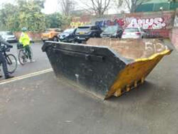 URGENT. Abandoned skip blocking cycle route on blind corner. Anyone coming round the corner in the dark will not see it as it is black and has no lights on it.
-Britannic House Westerley Crescent, Sydenham, SE26 5FN, England, United Kingdom