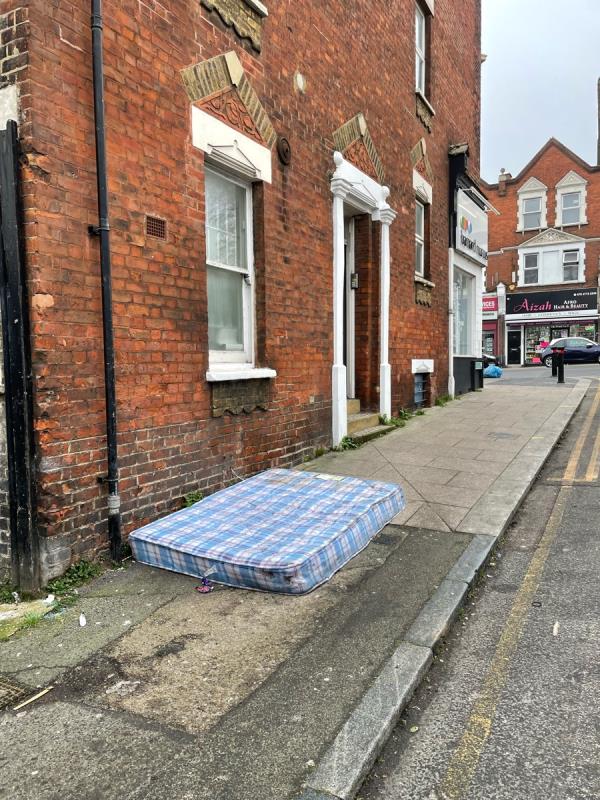 Mattress been dumped here for over two weeks. Blocking pathway which is dangerous trip hazard for pedestrians as well as looking terrible and attracting more rubbish -13b Sydenham Road, Sydenham, SE26 5EX, England, United Kingdom