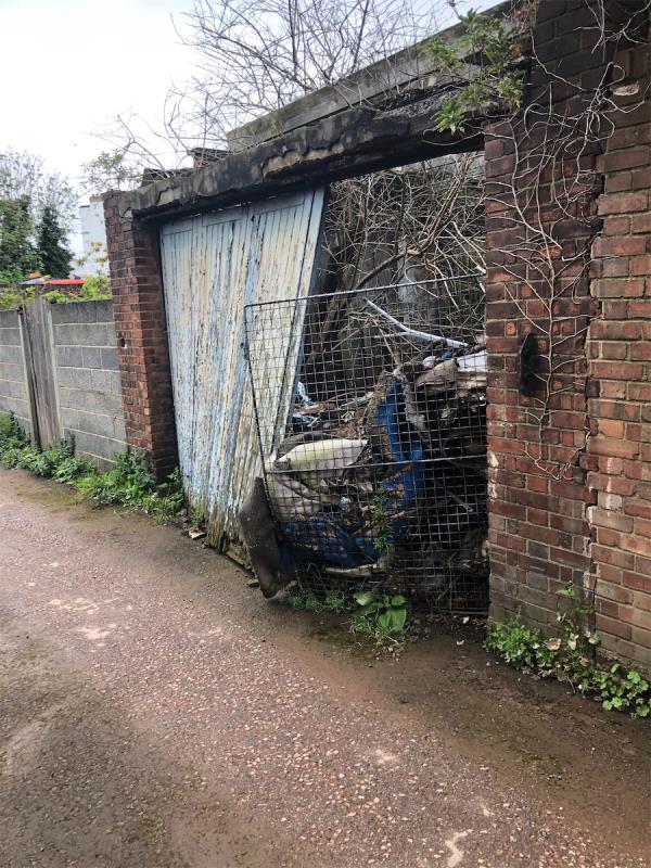 Flytipping in an old garage to rear of 455 New Cross Road. Please investigate ownership -2 Alpha Road, London, SE14 6TZ