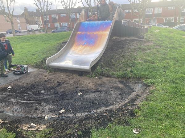Slide burnt and surrounding play equipment fenced off.-Upperton Road West, Plaistow, London