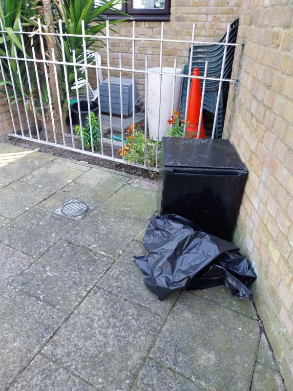 Dumped fridge and bag-1 Lambourne Grove, London, SE16 2RR