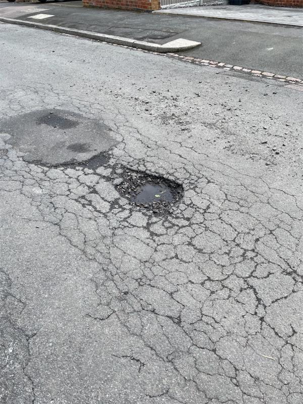 Pot hole outside no 31 and 29-31 Peters Drive, Leicester, LE5 2AQ