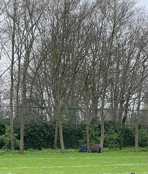 Not the correct category but related. Two people openly using drugs on the rugby field. There are children around -Whitelegg Road, Plaistow, London